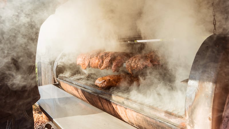 Large barbecue smoker grill at the park. Meat prepared in barbecue smoker. Restaurant. Background