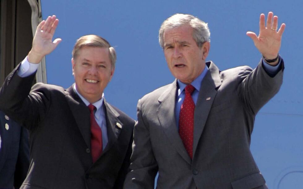**FILE**President Bush, right, and Sen. Lindsey Graham, R-S.C., wave to the crowd after...