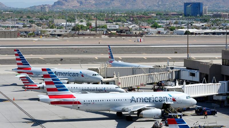 American Airlines planes wait at their gates at Phoenix Sky Harbor International Airport...