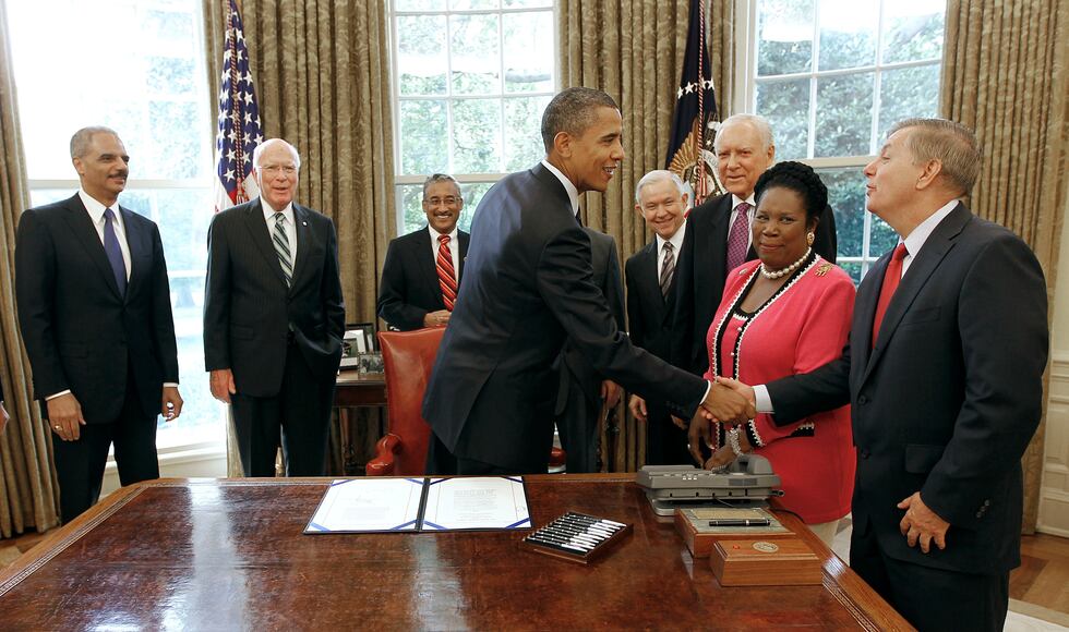 FILE - In this Aug. 3, 2010, file photo, President Barack Obama shakes hands with Sen. Lindsey...